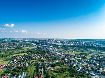 High angle view of buildings against blue sky