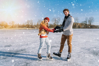 Full length of couple standing on snow