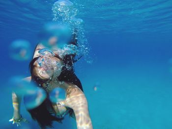 Close-up of young woman swimming in sea