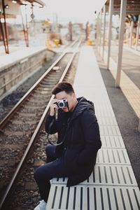 Young man on railroad station