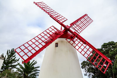 Low angle view of traditional windmill against sky