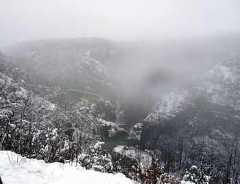 Scenic view of landscape against sky during winter