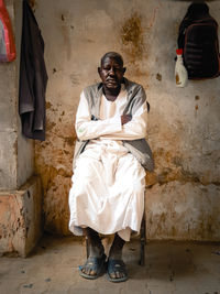 Low section of man standing against wall