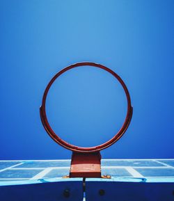 Low angle view of basketball hoop against blue sky