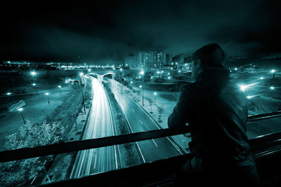 Nigth urban scene with young man,road and tunnel