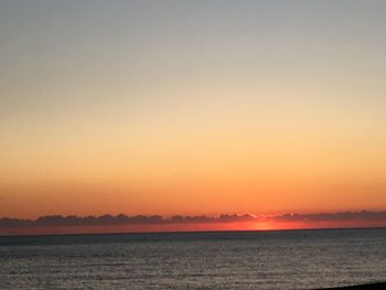 Scenic view of sea against clear sky during sunset