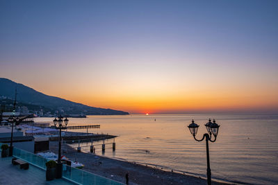 Scenic view of sea against clear sky during sunset