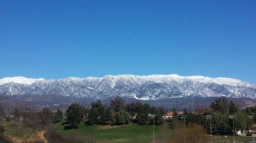 Scenic view of mountains against clear blue sky