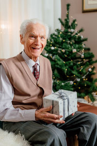 Portrait of young man using digital tablet while sitting at home