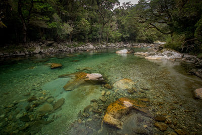 View of stream flowing through rocks