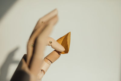 Close-up of woman hand over white background