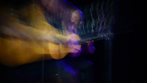 Digital composite image of man playing at music concert