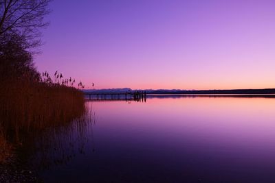 Scenic view of lake against romantic sky at sunset