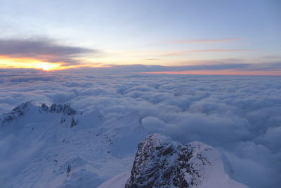 Scenic view of snowcapped mountains against sky during sunset