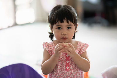 Portrait of cute girl holding camera