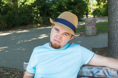 Portrait of man wearing hat standing outdoors