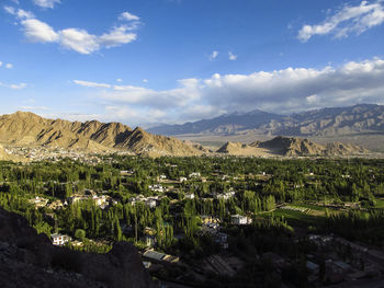 Scenic view of green landscape against sky