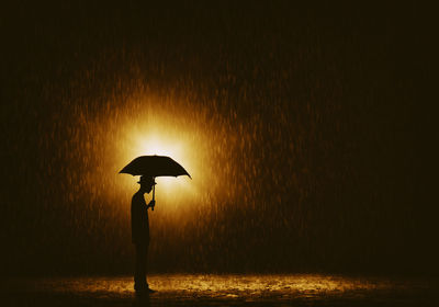 Silhouette lamp against sky during sunset