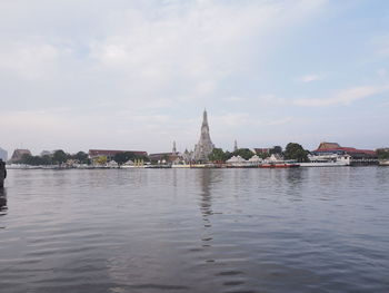 River amidst buildings against sky