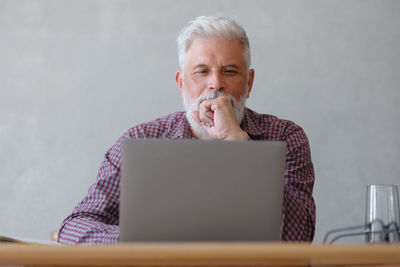 Man using laptop at table