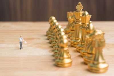 Close-up of chess pieces and figurine on table