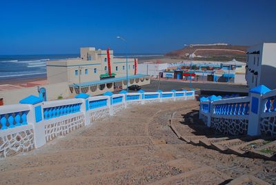 Scenic view of beach against clear blue sky