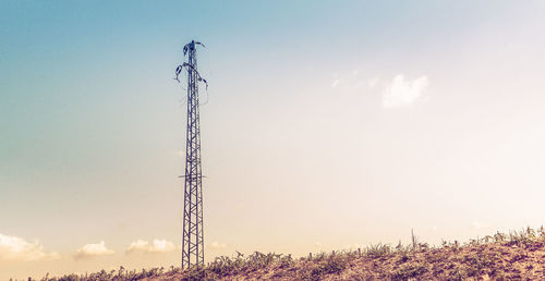 Low angle view of electricity pylon against sky