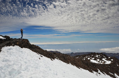 Man standing on snow covered landscape