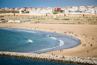 High angle view of people at beach against sky