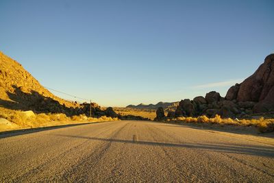 Scenic view of field against clear blue sky