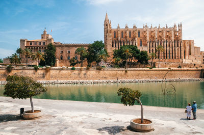 Palma cathedral and royal palace of la almudaina by river