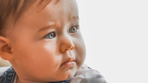 Close-up portrait of cute baby looking away