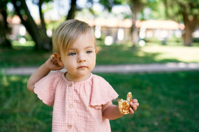 Portrait of cute girl holding plant