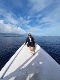 Full length of woman on sea against sky