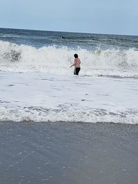 Full length of man on beach against sky