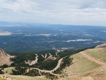 High angle view of road by mountains against sky