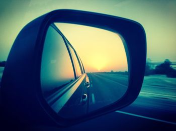Reflection of car on side-view mirror