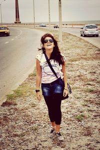 Portrait of woman standing on road