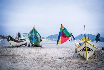 Scenic view of beach against cloudy sky