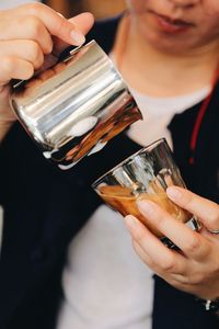 Midsection of woman holding drink