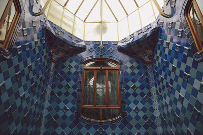 Low angle view of electric lamp hanging from ceiling