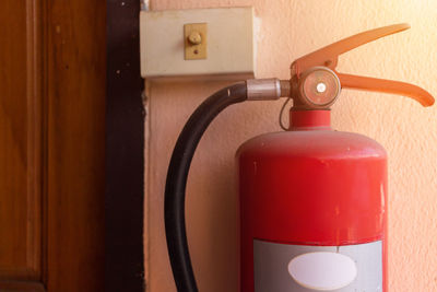 Close-up of fire extinguisher on wall