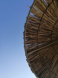 Low angle view of wood against clear blue sky