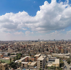 High angle view of cairo townscape against sky from citadel of saladin, pyramid of giza in distance