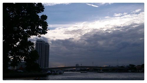 Buildings against cloudy sky