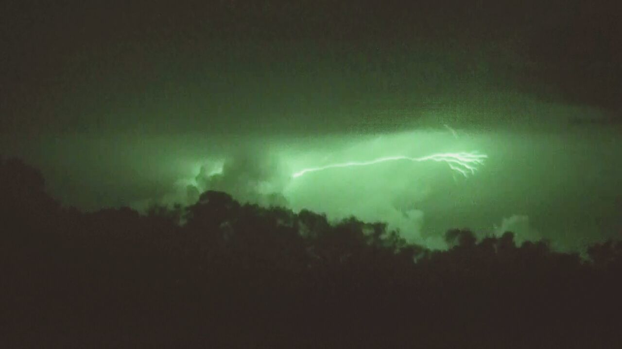 night, illuminated, sky, silhouette, lightning, light - natural phenomenon, glowing, smoke - physical structure, power in nature, low angle view, thunderstorm, long exposure, smoke, dark, outdoors, storm, danger, beauty in nature, copy space, nature