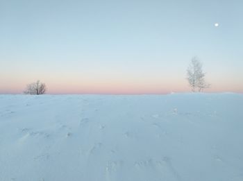 Scenic view of snow covered land against clear sky