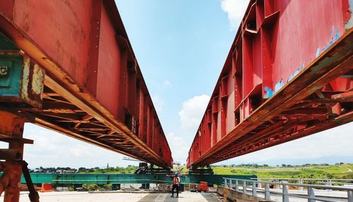 Male worker standing below bridge at construction site