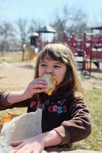 Girl eating food at playground