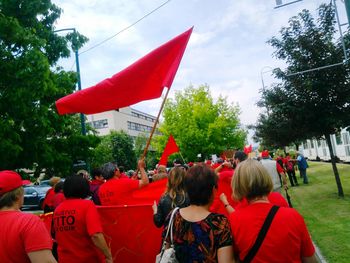 Rear view of people on red flags in city